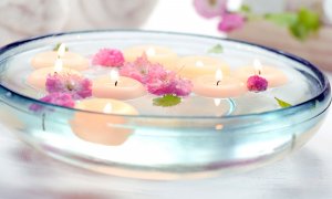 Elevation Med Spa Lone Tree Colorado bowl of water with lit candles and flowers in it