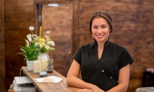 Elevation Med Spa Lone Tree Colorado spa technician wearing black at spa lobby ready to assist clients