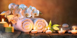 Elevation Med Spa Lone Tree Colorado relaxing spa atmosphere with it candles, rolled towels, and orchids